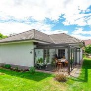 Hausansicht vom Garten mit Wintergarten